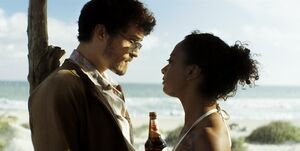 Orlando Bloom with glasses a beer and some chick on the beac