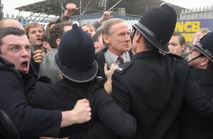 Bill Nighy and protester with messed up face in Pride