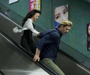 Chris Hemsworth and Wei Tang run down metro stairs