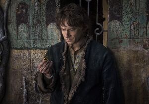 Martin Freeman as Bilbo Baggins looking at the precious ring