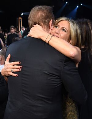Jennifer Aniston huggs a man at 2015 SAG Awards