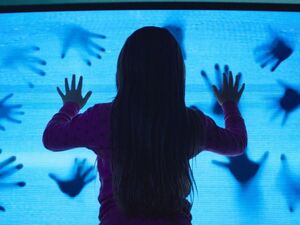 Hands Pushing Through Television
