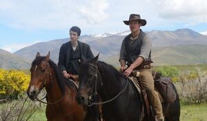Michael Fassbender and Kodi Smit-McPhee ride their horses in