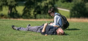 Rafe Spall and Asa Butterfield on the grass