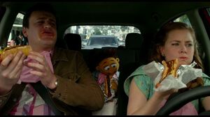 Walter, Jason Segel and Amy Adams stop to get hot dogs in The Muppets